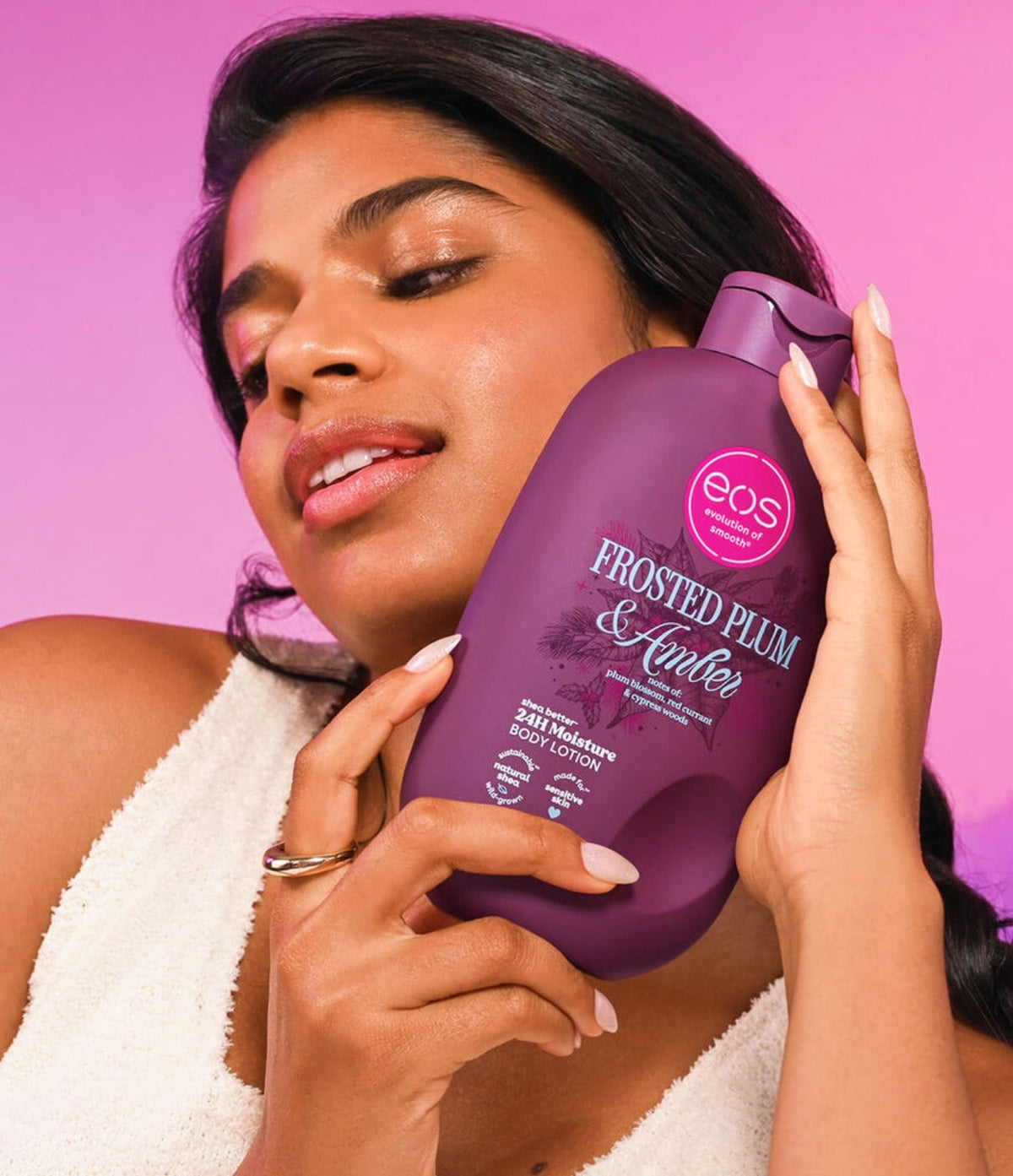 Woman holding EOS Frosted Plum & Amber lotion
