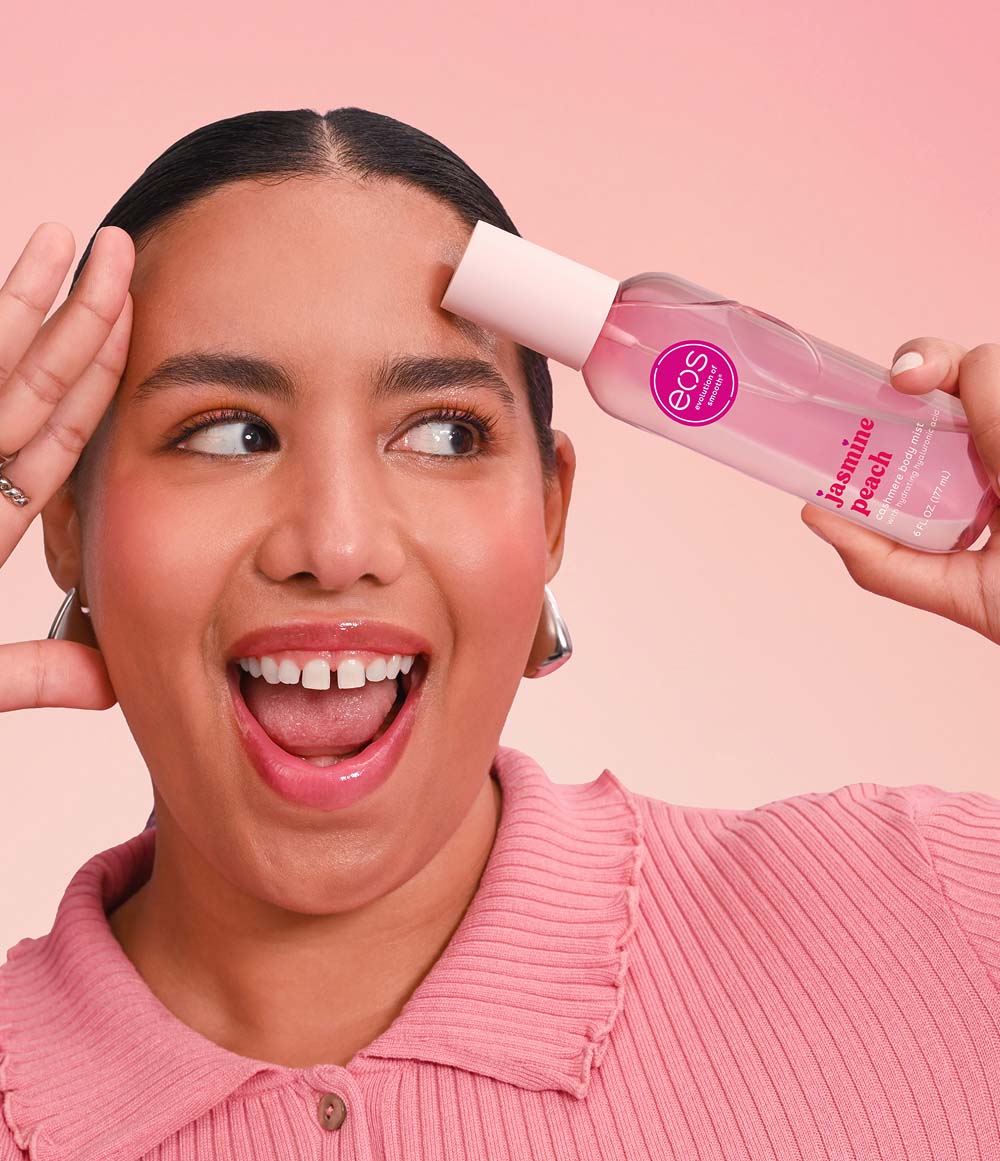 Model holding EOS Jasmine Peach body mist