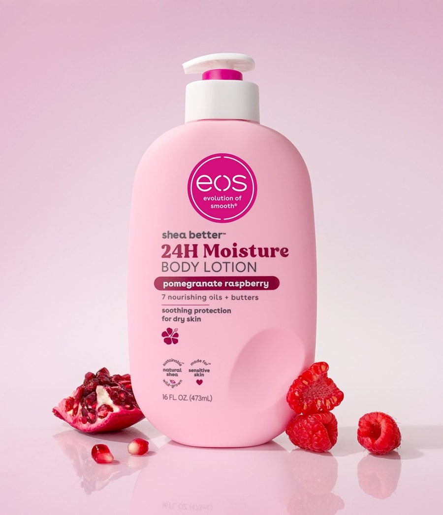 HAMYNAT EOS Pomegranate Raspberry body lotion in a pink pump bottle with fresh pomegranate and raspberries on a table