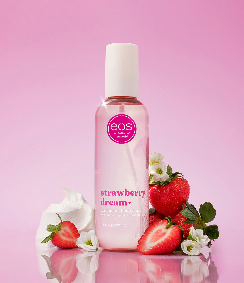 EOS Strawberry Dream body mist beside strawberries and white flowers