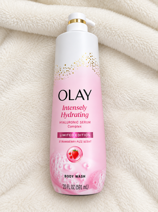 HAMYNAT Olay Intensely Hydrating Body Wash with Hyaluronic Serum in a pink bottle with strawberry scent on a blanket