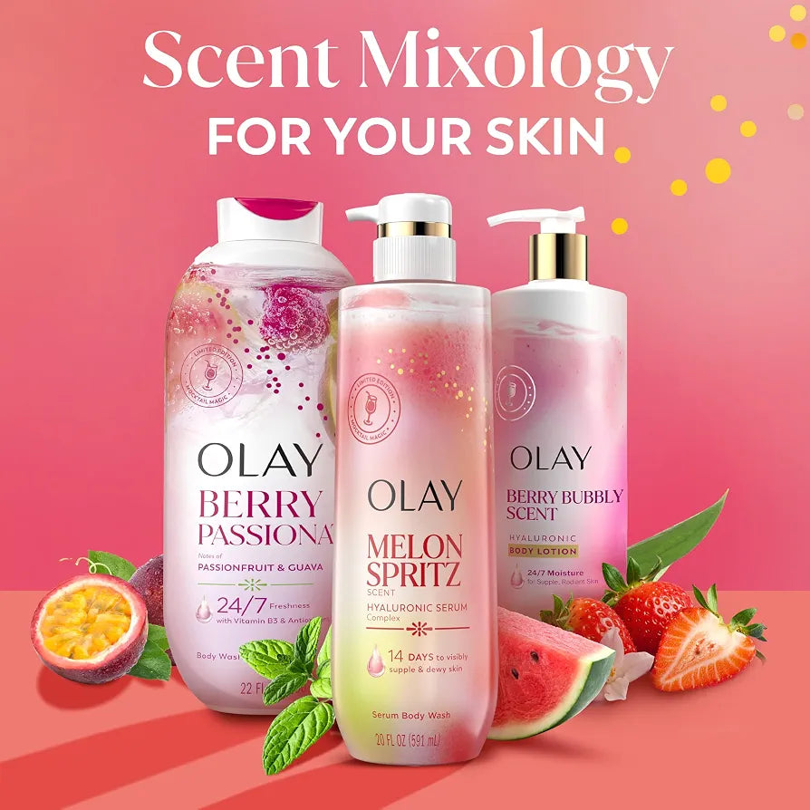 HAMYNAT Olay Melon Spritz and Berry Passion body wash bottles with fresh fruit and mint on a pink background.
