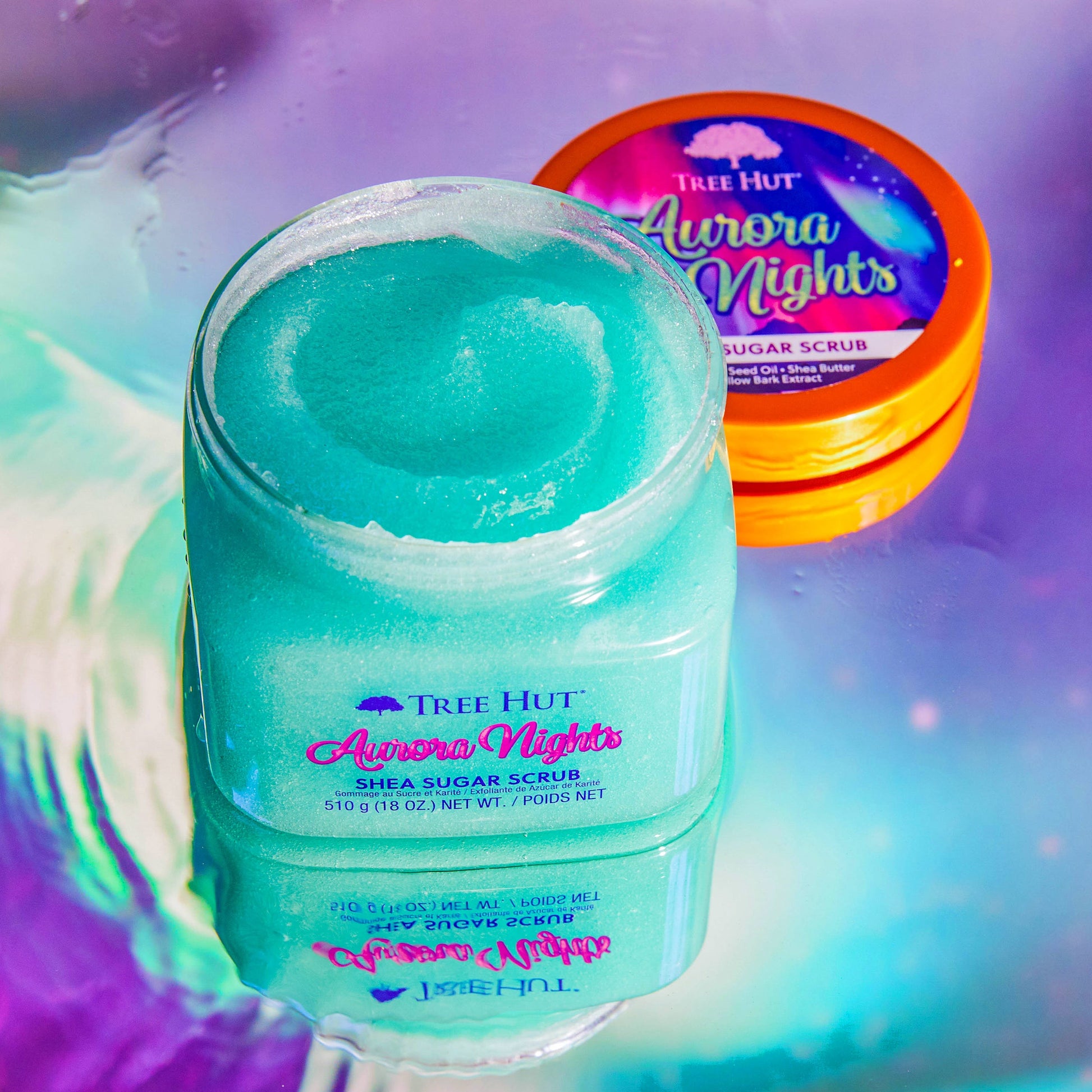 HAMYNAT Tree Hut Aurora Nights shea sugar body scrub in a teal shimmering texture on a reflective surface
