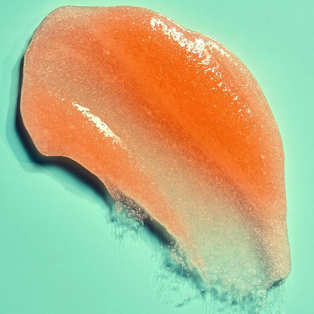 HAMYNAT Tree Hut Bikini Reef sugar scrub texture swatch showing a shimmering orange exfoliating gel on a teal background