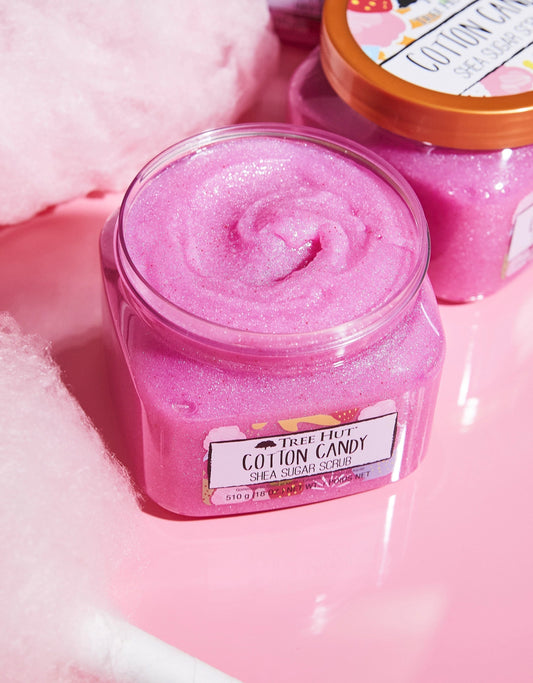 HAMYNAT Tree Hut Cotton Candy Shea Sugar Scrub in a pink, shimmering jar with a gold lid on a pink surface.