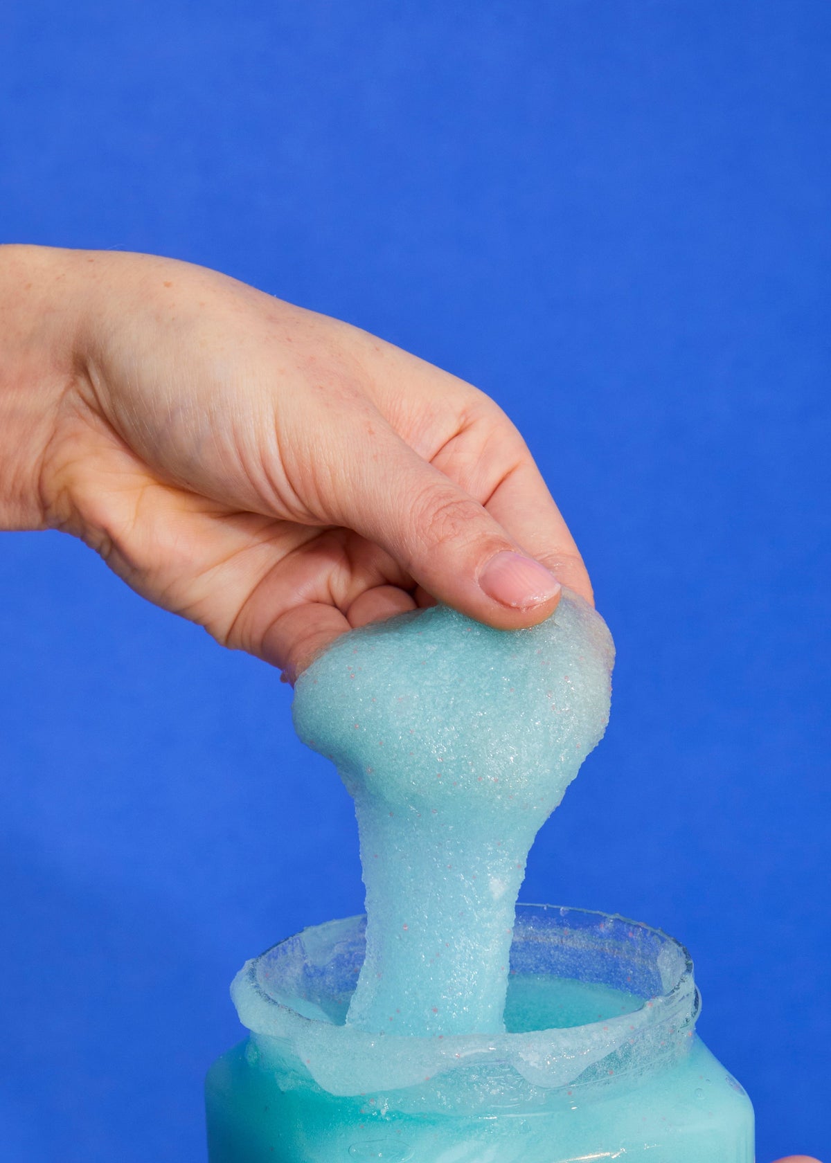 Tree Hut Lotus Water blue sugar scrub being scooped from the jar