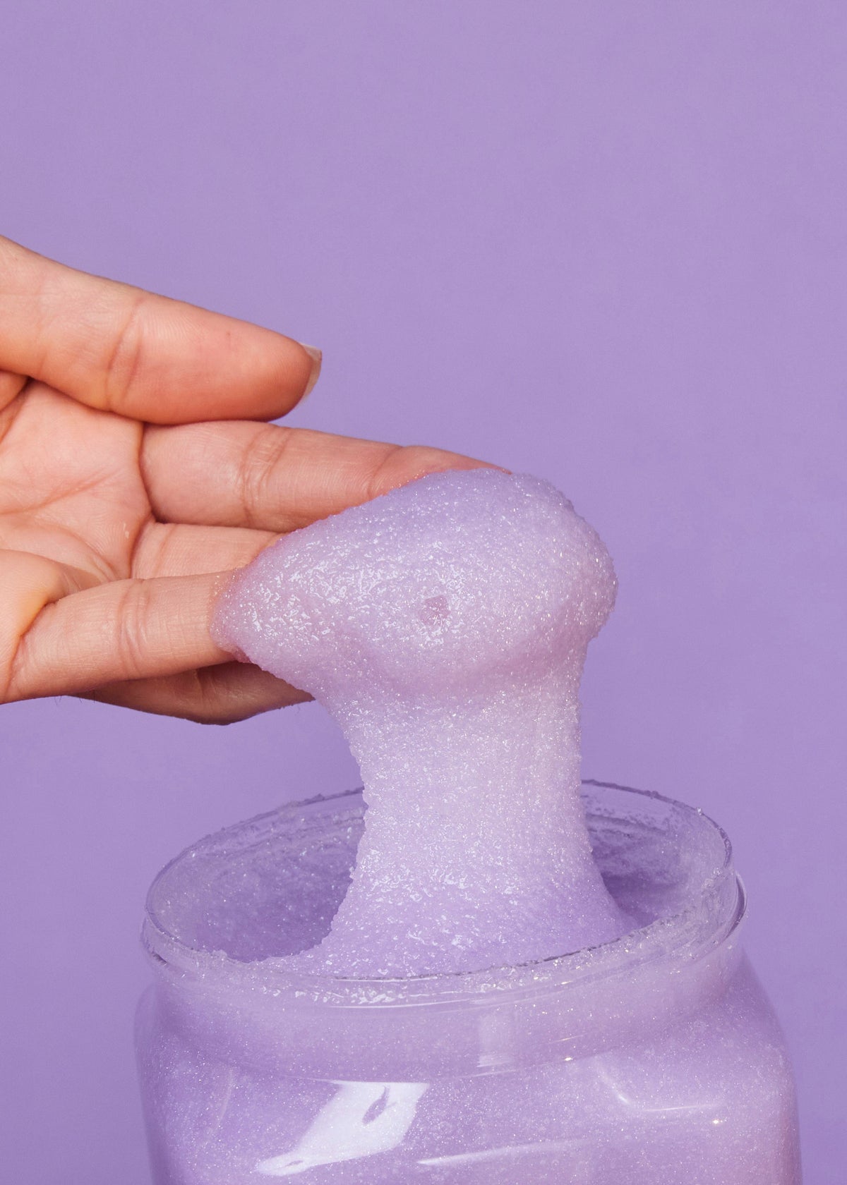 Tree Hut Moonlight Glow purple sugar scrub being scooped from the jar