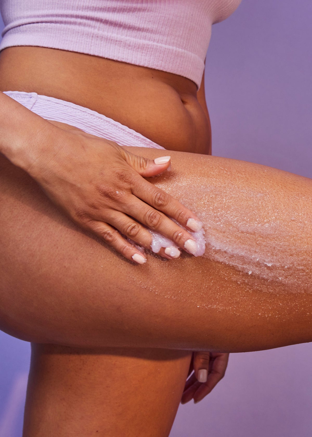 Tree Hut Moonlight Glow sugar scrub being applied to a thigh