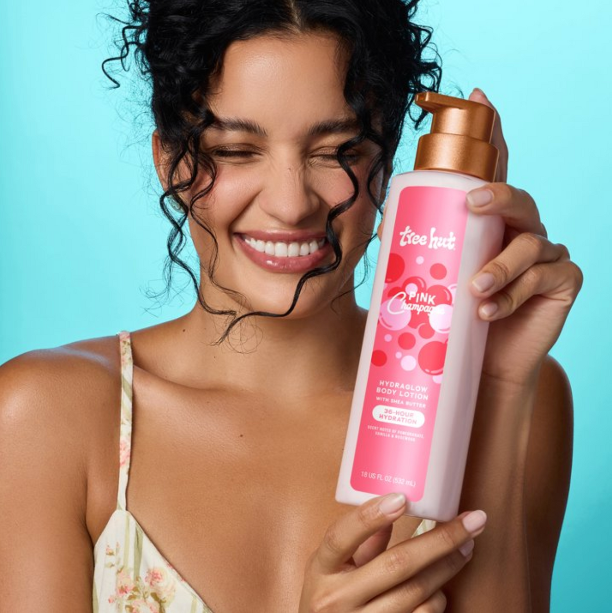 Model holding Tree Hut Pink Champagne Hydraglow Body Lotion