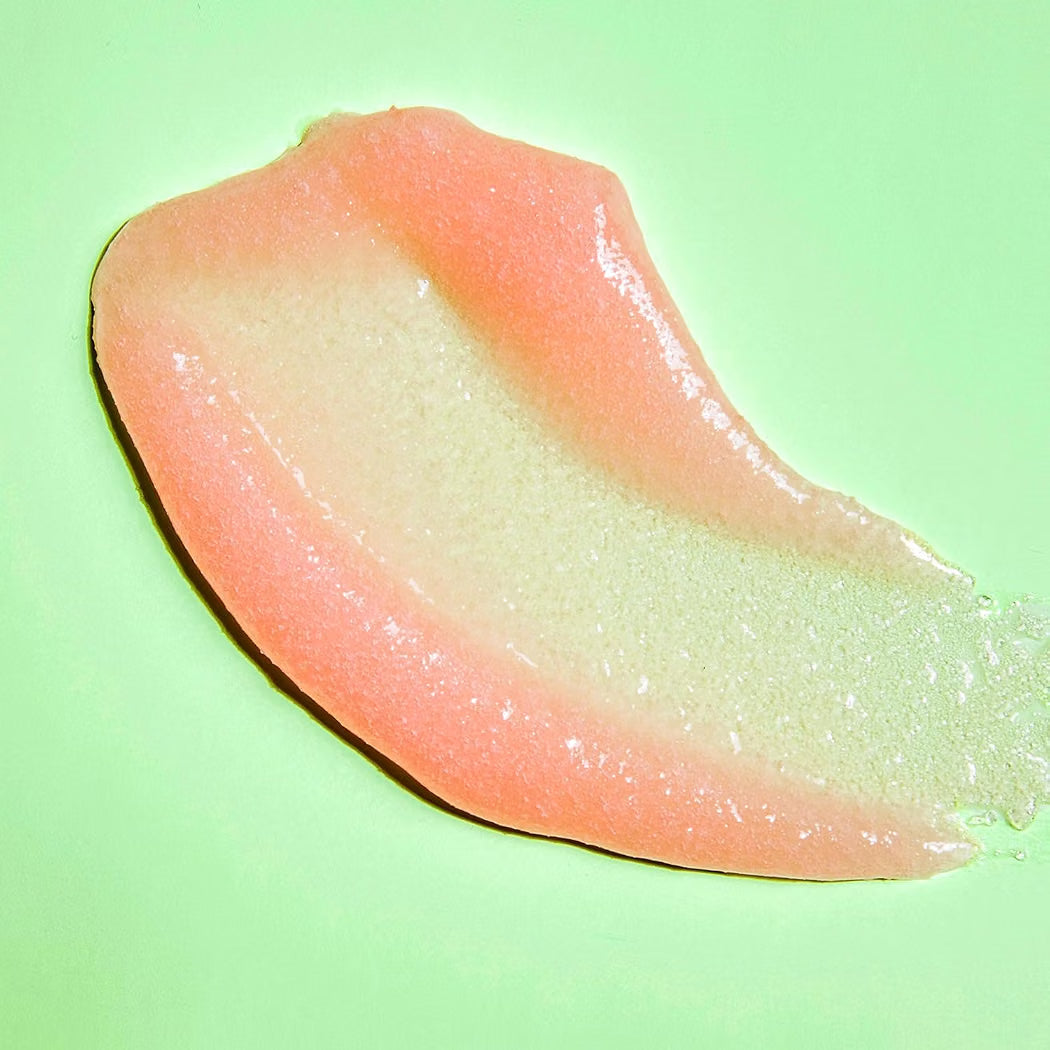 HAMYNAT Tree Hut Pink Hibiscus Shea Sugar Scrub texture showing a smooth, exfoliating pink sugar paste on green