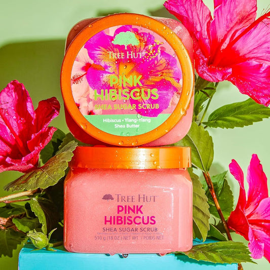 HAMYNAT Tree Hut Pink Hibiscus Shea Sugar Scrub in a pink jar surrounded by vibrant tropical hibiscus flowers.