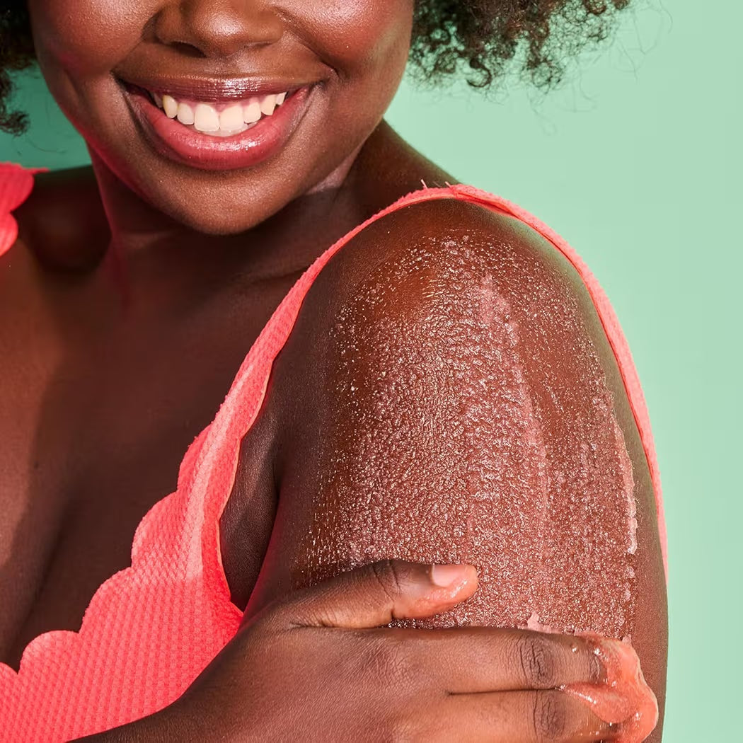 HAMYNAT Tree Hut Bikini Reef Shea Sugar Scrub being applied to a woman's shoulder for smooth, exfoliated skin