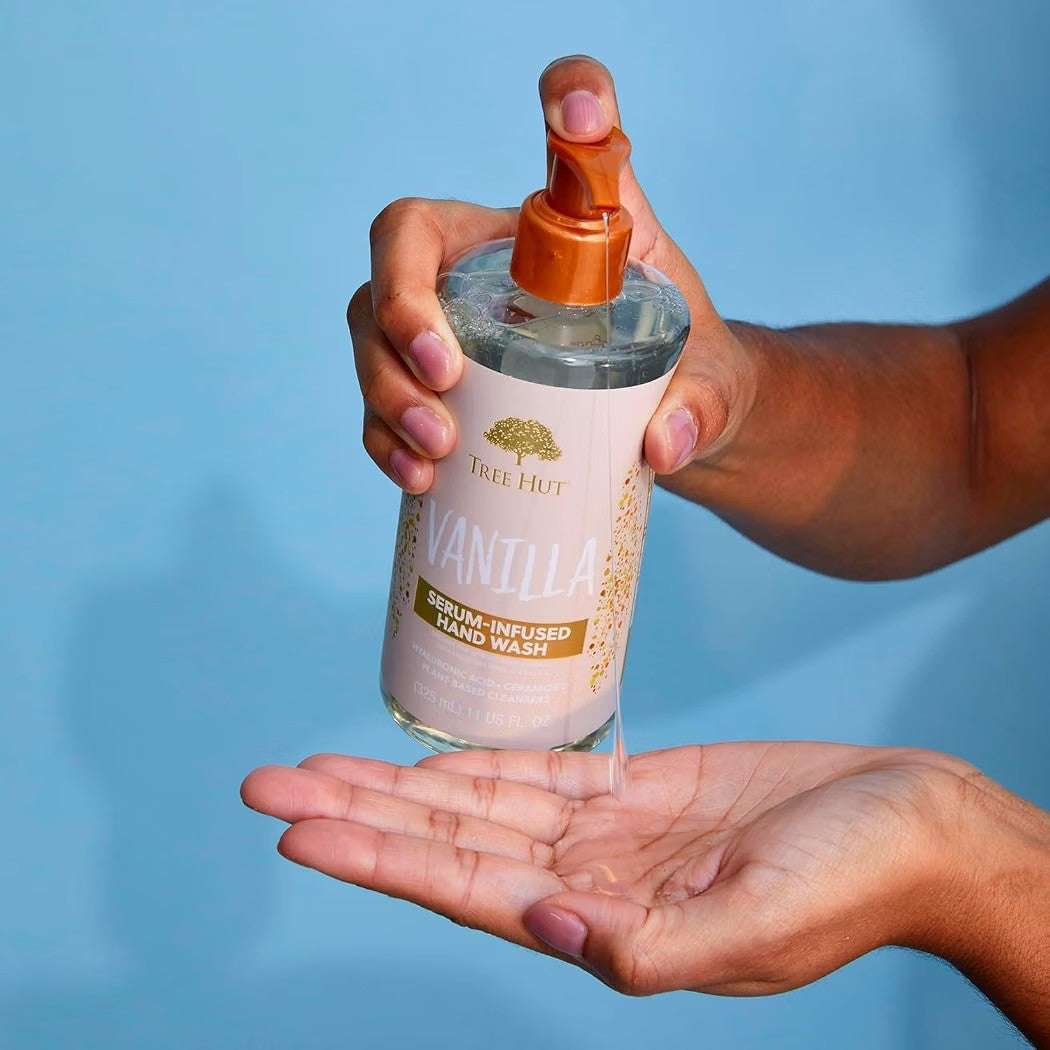 HAMYNAT Tree Hut Vanilla serum-infused hand wash being dispensed into a palm against a blue background