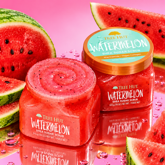 HAMYNAT Tree Hut Watermelon Shea Sugar Scrub jars with fresh watermelon slices on a reflective pink surface.
