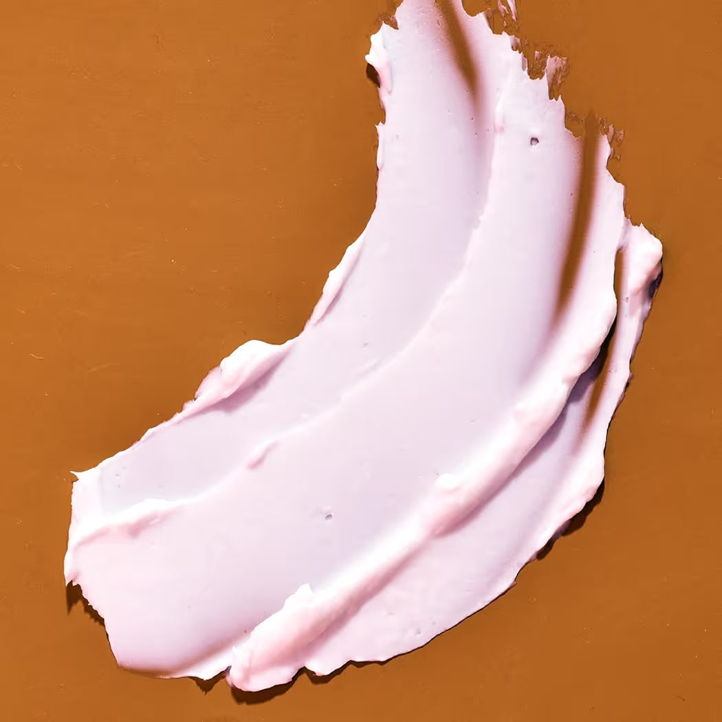 HAMYNAT Tree Hut Coco Colada whipped shea body butter texture swatch showing a smooth pale pink cream on brown background