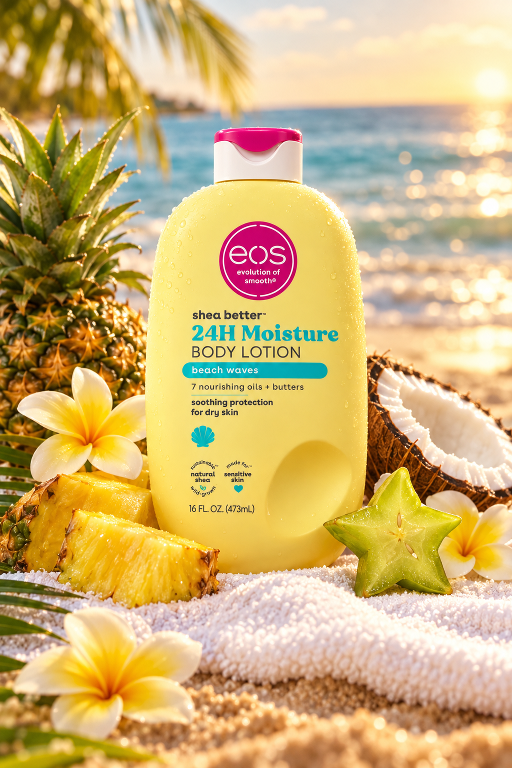 EOS Beach Waves body lotion 473ml bottle surrounded by pineapple coconut and tropical flowers on a sandy beach